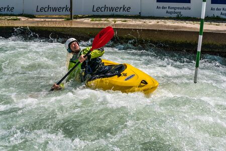 Augsburg, Germany - June 16, 2019: Whitewater kayaking, extreme kayaking. A guy in a kayak sails on the Eiskanal in Augsburg Germanyのeditorial素材