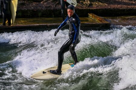 Munich, Germany - December 13, 2018: Surfer in the city river, Munich is famous for people surfing...