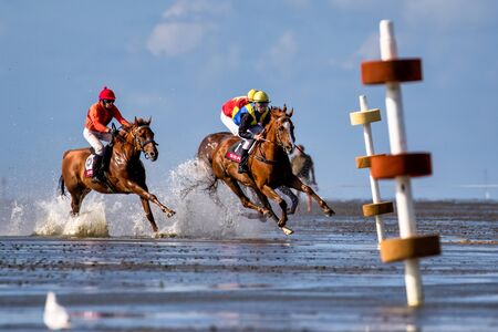 Cuxhaven, Germany - July 22, 2018: equestrian at the horse race in the mud flat at Duhner Wattrennen in Germanyのeditorial素材