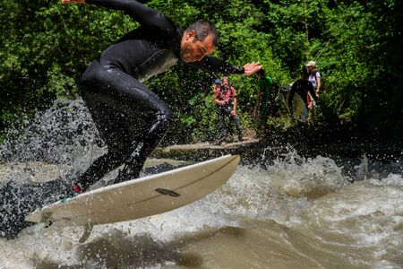 Munich, Germany - July 13, 2019: Surfer in the city river, Munich is famous for people surfing in...