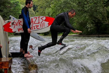 Munich, Germany - July 13, 2019: Surfer in the city river, Munich is famous for people surfing in...