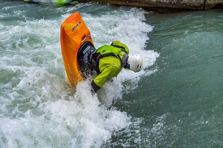 Augsburg, Germany - June 16, 2019: Whitewater kayaking, extreme kayaking. A guy in a kayak sails on...