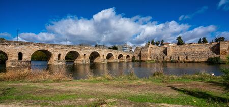 Historical Bridge, built by the Romans. It is the longest surviving Roman bridge, over the Guadiana River in Merida, Extremadura, Spain. Puente Romano is the Spanish name for the Roman Bridge. In the background we see the Alcazaba.の写真素材