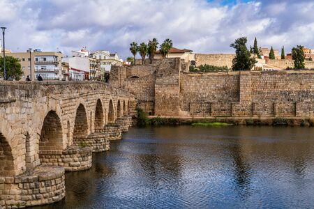 Merida, Spain - November 05, 2019: Puente Romano, the Roman Bridge in Merida. It is the longest surviving Roman bridge, over the Guadiana River in Merida. In the background we see the Alcazaba.のeditorial素材