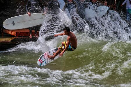 Munich, Germany - July 13, 2019: Surfer in the city river, Munich is famous for people surfing in...