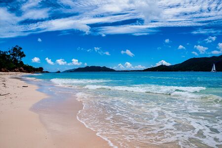 view of the coastline white sand beach and turquoise water of the island of Curieuse, Seychellesの写真素材