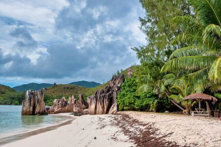 view of the coastline white sand beach and turquoise water of the island of Curieuse, Seychellesの写真素材