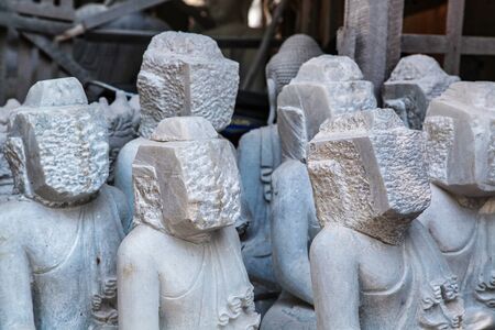 carving Buddha statues from stone in a street workshop in Mandalay, Myanmar former Burmaの写真素材