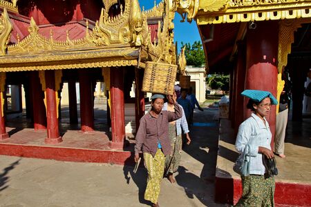 Bagan, Myanmar - Nov 14, 2019: Burmese people in the golden Shwezigon Pagoda or Shwezigon Paya in...