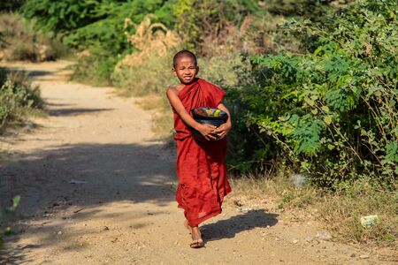 Bagan, Myanmar - Nov 16, 2019: Burmese monk beg for alms in the morning in Bagan, Myanmar former Burma in Asiaのeditorial素材