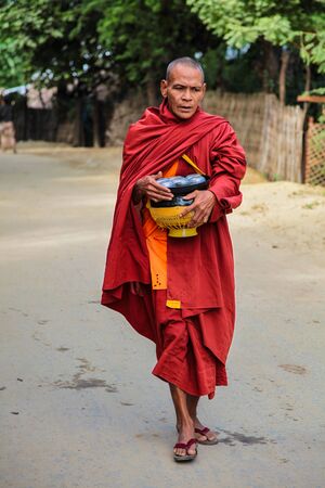 Bagan, Myanmar - Nov 16, 2019: Burmese monk beg for alms in the morning in Bagan, Myanmar former...