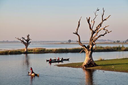 Mandalay, Myanmar - Nov 12, 2019: Fishermen near U Bein bridge in Amarapura,Mandalay Myanmar