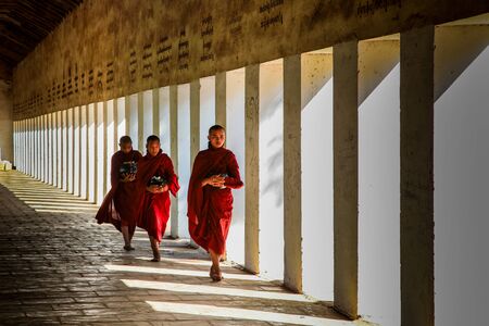 Bagan, Myanmar - Nov 14, 2019: Burmese monks in the golden Shwezigon Pagoda or Shwezigon Paya in Bagan, Myanmar former Burma in Asiaのeditorial素材