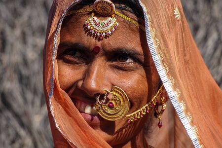 Jaisalmer, India - Jan 01, 2020: Rajasthani gypsy woman in traditional tribal attire and jewelry