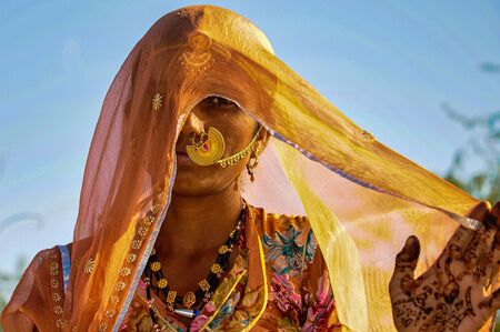 Jaisalmer, India - Jan 01, 2020: Rajasthani gypsy woman in traditional tribal attire and jewelryのeditorial素材