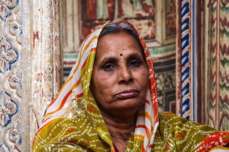 Nawalgarh, India - Dec 28, 2019: Women dressed in traditional sari sitting in front of a haveli of Rajasthan in Nawalgarhのeditorial素材