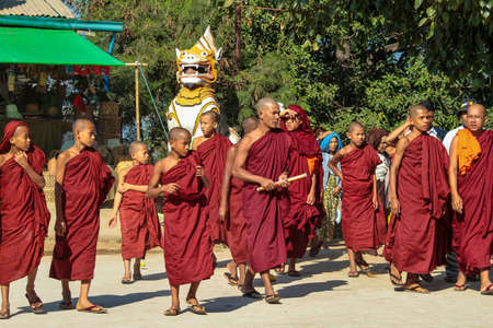 Bagan, Myanmar - Nov 14, 2019: Burmese monks in the golden Shwezigon Pagoda or Shwezigon Paya in...