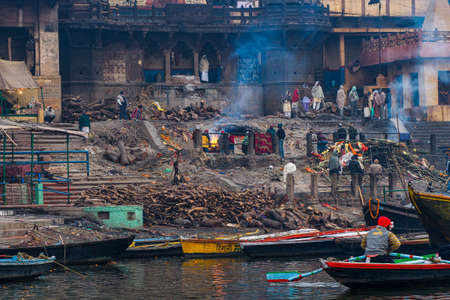 Varanasi, India - Dec 26, 2019: Cremation of bodies at the holiest Manikarnika Ghat on the banks of the Ganges river in Varanasi, India.のeditorial素材