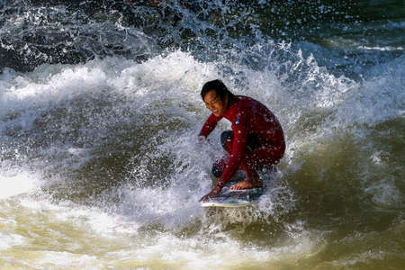 Munich, Germany - July 13, 2019: Surfer in the city river, Munich is famous for people surfing in urban enviroment called Eisbachのeditorial素材
