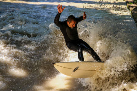 Munich, Germany - July 13, 2019: Surfer in the city river, Munich is famous for people surfing in urban enviroment called Eisbachのeditorial素材