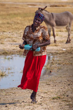 Opuwo, Namibia - Jul 06, 2019: Namibian women with her donkey, seen in Opuwo in the Kunene Region of...