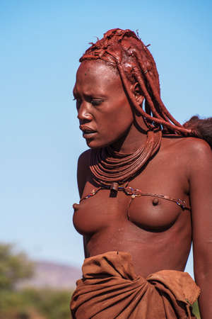 Opuwo, Namibia - Jul 07, 2019: Unidentified Himba woman with the typical necklace and hairstyle in...