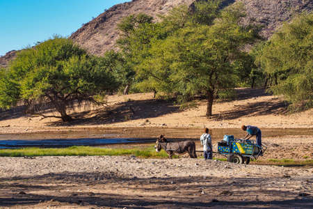 Sesfontein, Namibia - Jul 09, 2019: Namibian men with their donkeys, seen in Sesfontein in the...