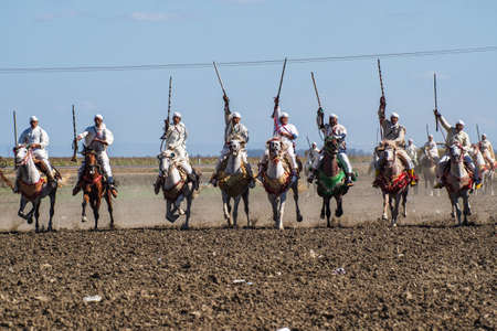 Rabat, Morocco - Oct 13, 2019: Local equestrians participate in a traditional fantasia event or MOUSSEM TBOURIDA in Arabic and wearing a traditional Moroccan dress and accessoriesのeditorial素材