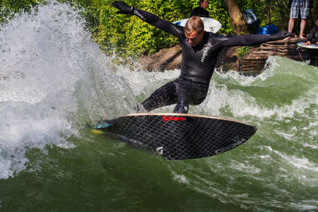 Munich, Germany - July 13, 2019: Surfer in the city river, Munich is famous for people surfing in...