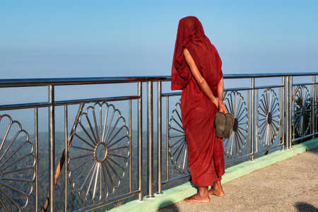 Kyaiktiyo, Myanmar - Nov 04, 2019: Monk at Kyaiktiyo Pagoda also known as Golden Rock is a well-known Buddhist pilgrimage site in Myanmar, Night view of Burmese pagoda, Golden rock, Balancing rockのeditorial素材