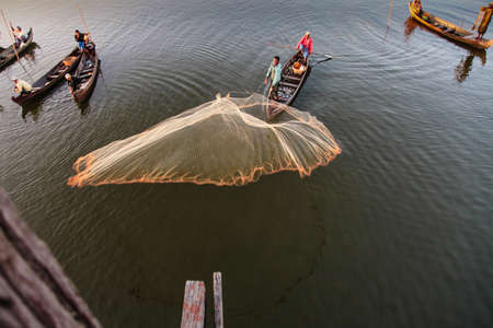 Mandalay, Myanmar - Nov 12, 2019: Fishermen near U Bein bridge in Amarapura,Mandalay Myanmarのeditorial素材
