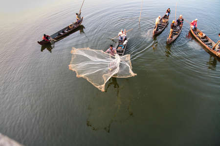 Mandalay, Myanmar - Nov 12, 2019: Fishermen near U Bein bridge in Amarapura,Mandalay Myanmarのeditorial素材