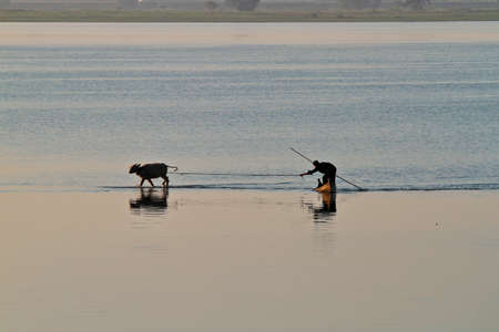 Mandalay, Myanmar - Nov 12, 2019: Fishermen near U Bein bridge in Amarapura,Mandalay Myanmarのeditorial素材