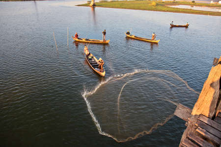 Mandalay, Myanmar - Nov 12, 2019: Fishermen near U Bein bridge in Amarapura,Mandalay Myanmarのeditorial素材