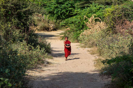 Bagan, Myanmar - Nov 16, 2019: Burmese monk beg for alms in the morning in Bagan, Myanmar former Burma in Asiaのeditorial素材