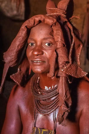 Opuwo, Namibia - Jul 07, 2019: Unidentified Himba woman with the typical necklace and hairstyle in...