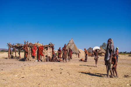 Opuwo, Namibia - Jul 07, 2019: Unidentified Himba women with the typical necklace and hairstyle in...