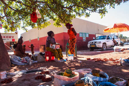 Opuwo, Namibia - Jul 07, 2019: Unidentified Himba women with the typical necklace and hairstyle in the streets of Opuwoのeditorial素材