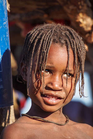 Opuwo, Namibia - Jul 07, 2019: Young unidentified Himba infant in a himba tribe villageのeditorial素材