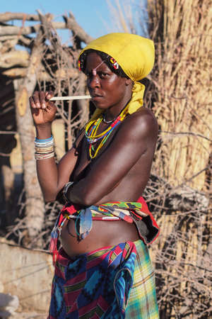 Opuwo, Namibia - Jul 07, 2019: Unidentified Himba woman with the typical necklace and hairstyle in...
