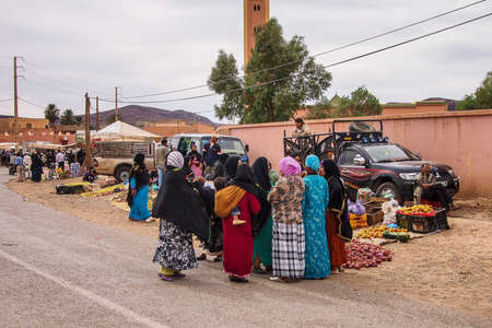 Erfoud, Morocco - Oct 19, 2019: local residents at the Road of a Thousand Kasbahs in their...