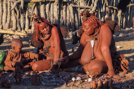 Opuwo, Namibia - Jul 08, 2019: Unidentified Himba woman with the typical necklace and hairstyle in himba tribe villageのeditorial素材