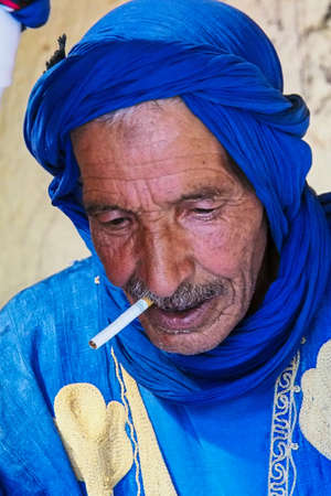Erfoud, Morocco - Oct 17, 2019: Old Berber man living in the moroccan mountains in Ksar Maadid near...