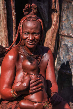 Opuwo, Namibia - Jul 07, 2019: Unidentified Himba woman with the typical necklace and hairstyle in...