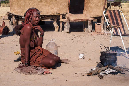 Opuwo, Namibia - Jul 07, 2019: Unidentified Himba woman with the typical necklace and hairstyle in...