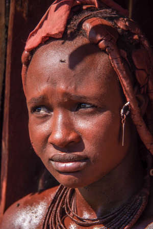 Opuwo, Namibia - Jul 07, 2019: Unidentified Himba woman with the typical necklace and hairstyle in...