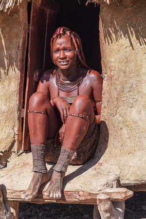 Opuwo, Namibia - Jul 07, 2019: Unidentified Himba woman with the typical necklace and hairstyle in...