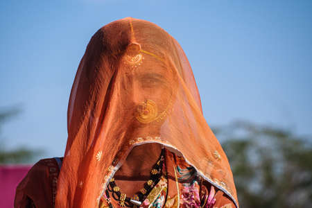 Jaisalmer, India - Jan 01, 2020: Rajasthani gypsy woman in traditional tribal attire and jewelryのeditorial素材