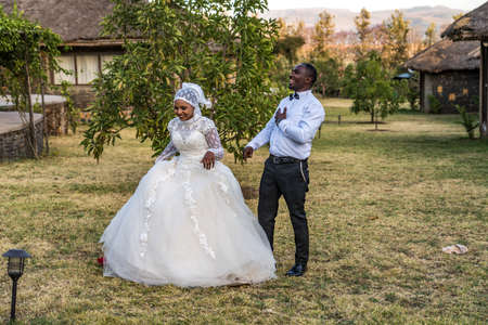Gondar, Ethiopia - Feb 06, 2020: Bridal couple poses for a portrait taken at Fasil Ghebbi, the remains of a fortress-city within Gondar, Ethiopia in Africaのeditorial素材