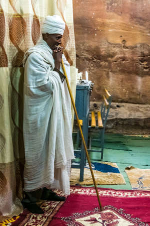 Wukro Cherkos, Ethiopia - Feb 11, 2020: Priest at the rocky church of Wukro Cherkos in Ethiopia,...